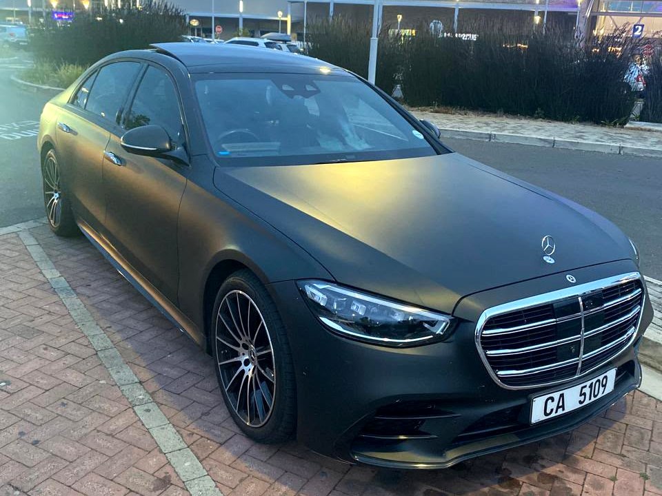 Dark Mercedes S-Class sedan photographed at the airport at dusk